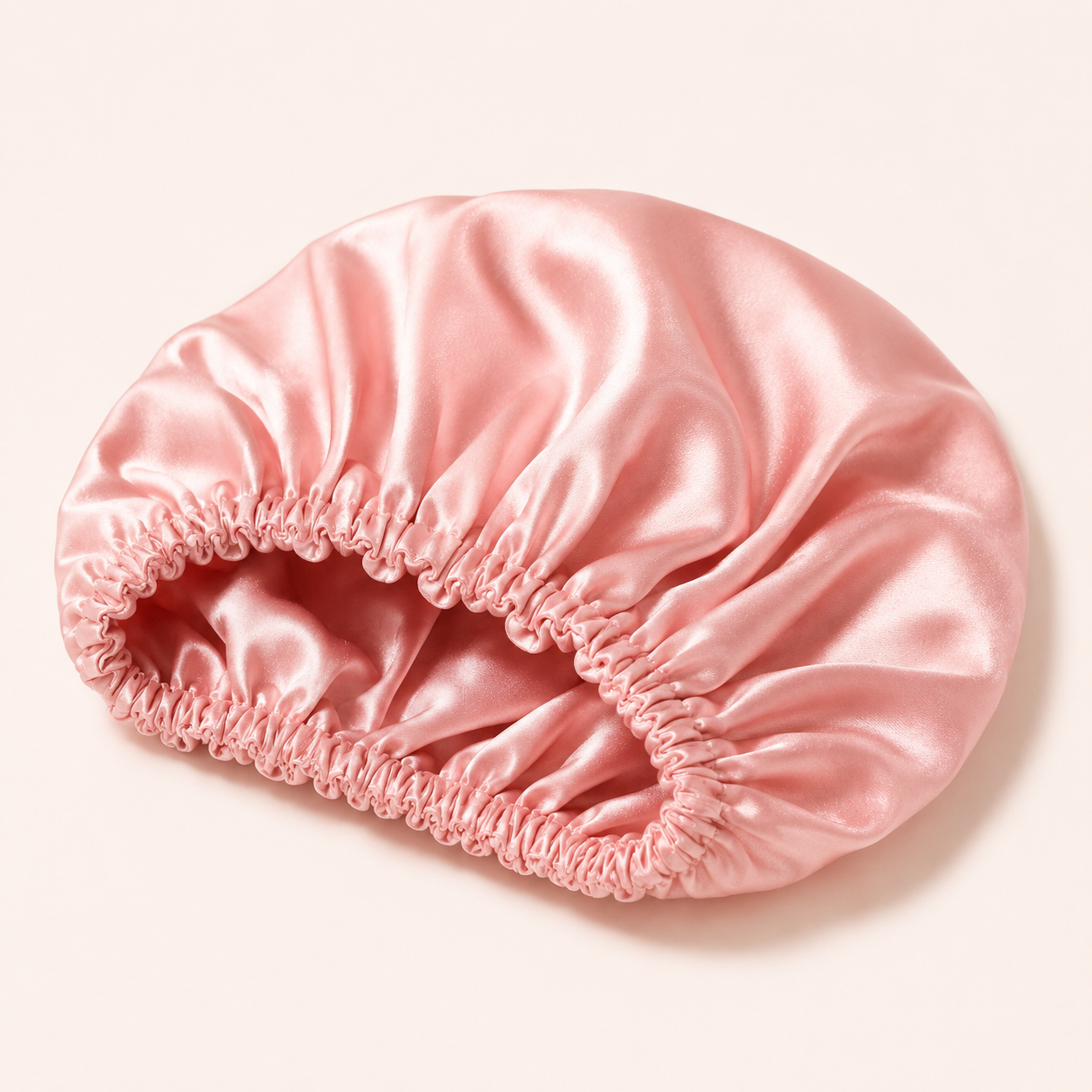 Pink satin-style hair bonnet with ruffled trim for sleeping